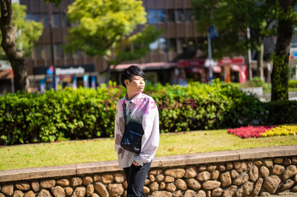 歩道で振り向く男性の写真